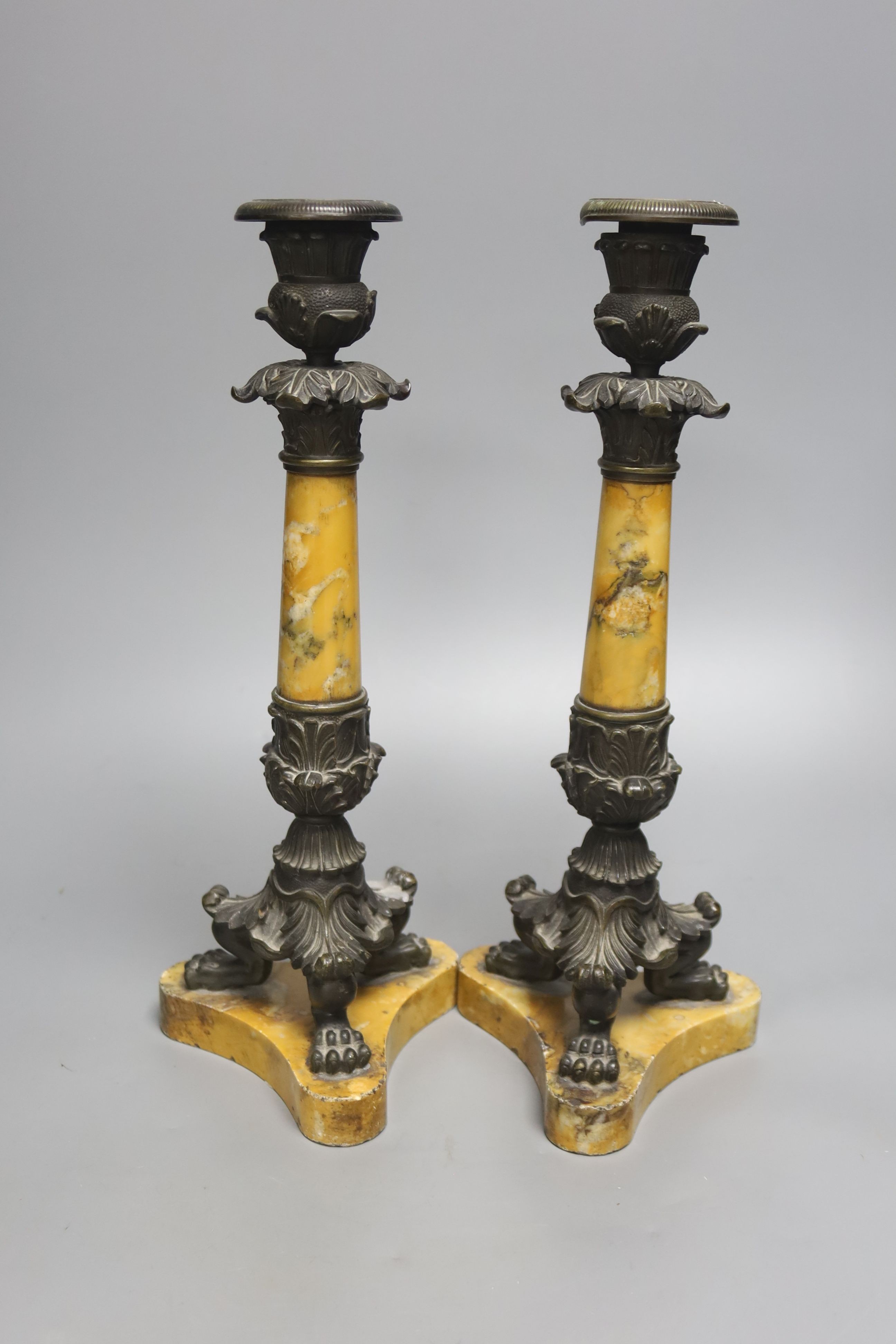 A pair of Empire bronze and Sienna marble candlesticks, height 32cm